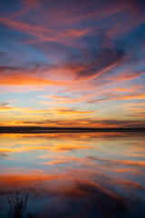 Fototapeta na wymiar End of the day on a lake, sunset and light in the clouds- Tunisia