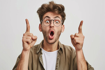 portrait of excited and shocked young man on isolated white background