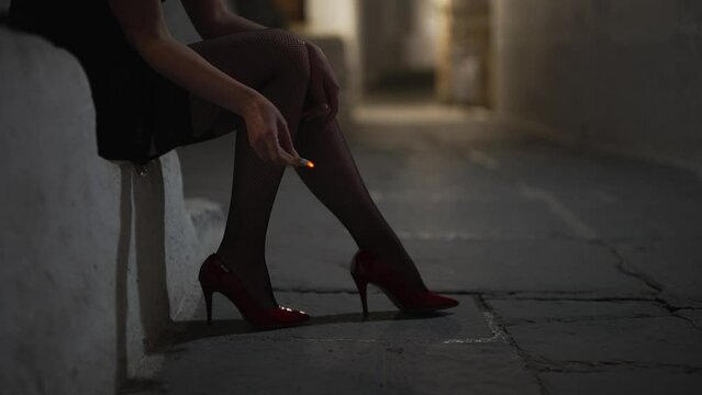 Female prostitute with cigarette on the street.
