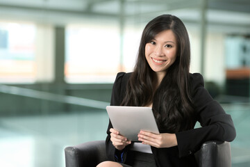 Chinese woman using a touch pad PC.