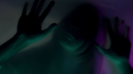 Blurred silhouette of a woman behind a mat curtain, in pink and green neon light, close up. A woman is scraping her fingernails on the barrier, trying to tear it. The concept of ghosts and spirits.