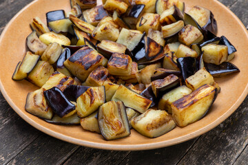 Sauteed aubergine chunks on a plate.