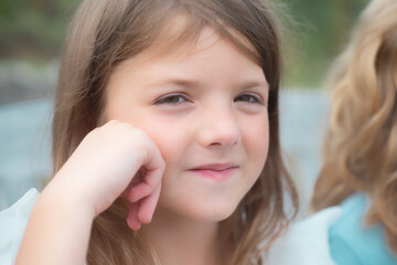 Kids dreaming face. Lifestyle portrait of cute kid outdoors. Summer kids outdoor portrait. Portrait of cute thoughtful child girl. Dreaming people.