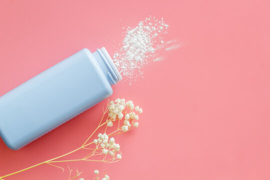 Spilled baby talcum powder. Container with powder for baby body care