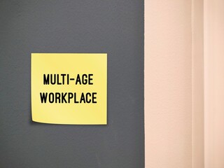 Office wall with stick note written MULTI-AGE WORKPLACE, refers to multi-generational workforce and...