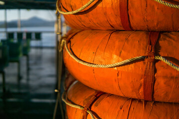 Close up of Orange lifebuoy on a boat in the port.