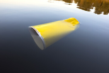 Water pollution. Coffee paper cup Garbage. Marine pollution. Aquatic trash. Paper coffee cup Waste in lake. Wastewater management. Litter in water, garbage, waste in ocean. Paper cup litter in lake