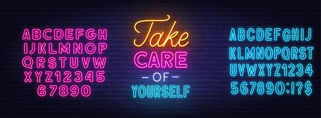 Take Care of Yourself neon lettering on brick wall background