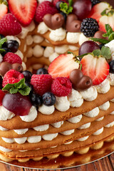 Fruit and Cream Layered Cake on Festive Table - 718866845
