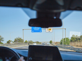 A view of s'Arenal Palma and a golf direction sign on the highway in Palma de Mallorca, Spain