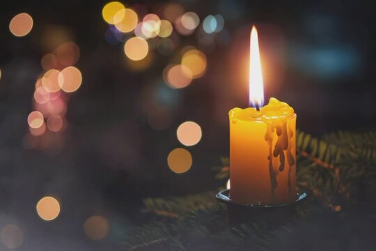 In the darkness of the night, white candles illuminate the scene, with a single candle in the foreground capturing the focus. seamless looping time-lapse virtual 4k video animation background.