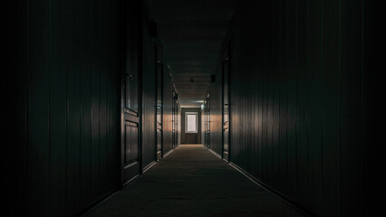gloomy dark corridor of an empty hotel without people during quarantine