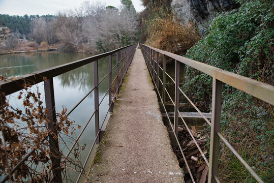 Photo of a footbridge with a lock on the Cal T&agrave;pies Canal in Navarcles, Spain. 