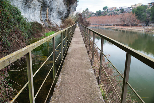 Photo of a footbridge with a lock on the Cal T&agrave;pies Canal in Navarcles, Spain. 