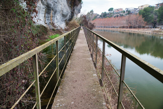 Photo of a footbridge with a lock on the Cal T&agrave;pies Canal in Navarcles, Spain. 