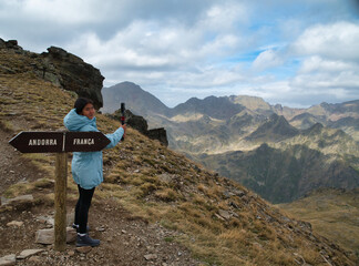 Fototapeta premium Girl hiker recording a video in Tristaina viewpoint in andorra, in high mountain in the andorran and french Pyrenees.