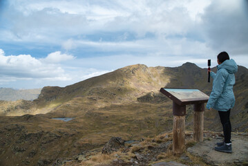 Girl hiker taking a selfie at the Tristaina viewpoint in Andorra, in high mountain in the Andorran...