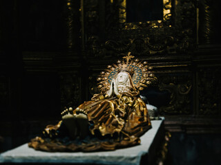A close-up focus on the serene face of the statue of Sleeping Mary in prayer inside the Catedral-Basilica de Santa Maria de Mallorca, capturing the essence of her devotion