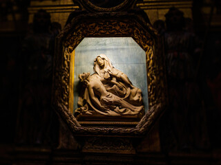 A statue of a Saint Maria woman tenderly holding Jesus at the Catedral-Baslica de Santa Maria in Palma de Mallorca.