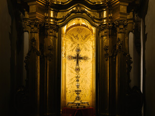 A magnificent golden cross suspended within the Catedral-Basilica de Santa Maria de Mallorca, radiating divine elegance