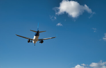 Fototapeta na wymiar Passenger airplane, flying in the blue sky
