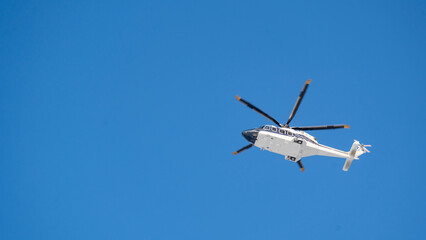 Passenger helicopter on blue sky background, helicopter taxi, passenger delivery on a helicopter, transport aviation