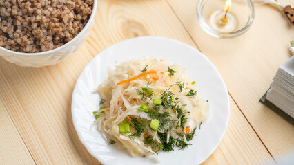 Sauerkraut and herbs on a wooden table. Lenten food during the Great Orthodox Lent