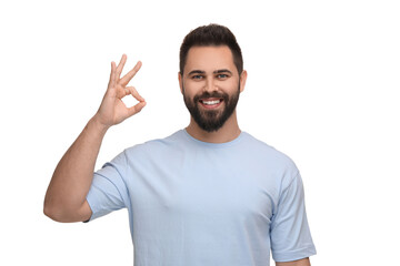 Man with clean teeth showing OK gesture on white background