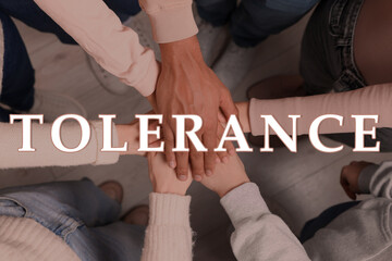 Tolerance, support and cooperation concept. Group of multiracial people joining hands together, top...