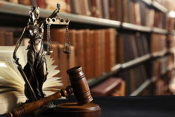 Law. Statue of Lady Justice, gavel and open book on black table indoors, space for text