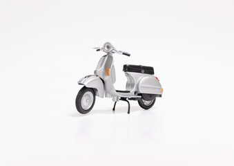 Miniature classic scooter on white background. After some edits. © Figan