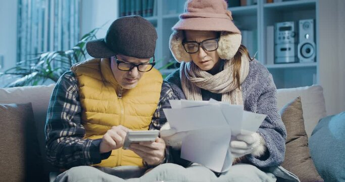 Desperate couple checking bills at home