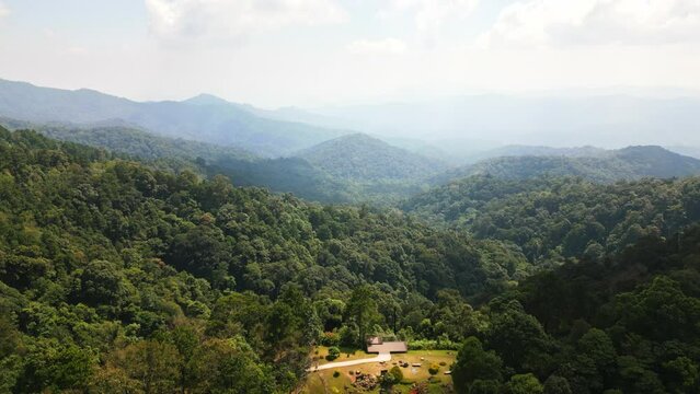 Aerial drone fly near Kew Fin viewpoint, Thailand. View of deep forest, mountains and hills in jungle. Cloudy weather.