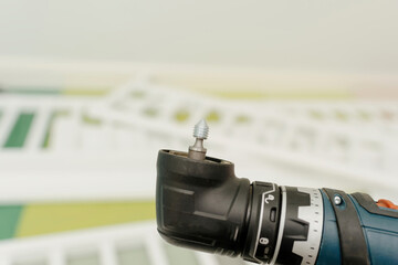 An extreme close-up macro shot captures furniture assembly with a drill and metallic screw on the top of the flexi drill head, showcasing precision craftsmanship