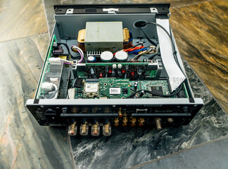 Munich, Germany - Sep 11, 2023: An image showing the inner components of an Onkyo R-N855 Made in Japan amplifier network streamer electronic device placed on a stone marble slate background