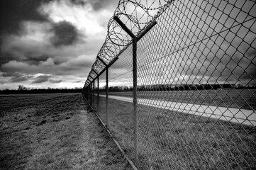 Barbed wire fence on the sunset black and white photography