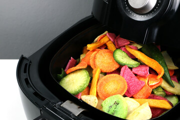homemade fried dried vegetables and fruits such as carrot, potato, kiwi, roselle are cooked by...
