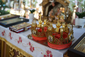 Church crowns on the throne in the church. Church wedding traditions