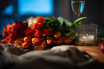 Romantic still life with red roses and tulips, champagne and candlelight. Background concepts for...