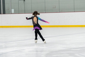 Figure skating practice at an indoor skating rink