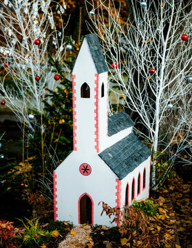 A small toy church house stands as part of the festive decorations at the annual Christmas market in the historic city of Colmar, Alsace, France