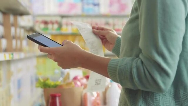 Customer checking her shopping receipt at the store