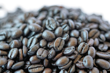 Roasted coffee beans on white background