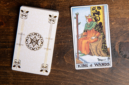 London, UK: 4 January, 2024: Minor Arcana - King of Wands of Tarot Card of Rider Waite deck on wooden background