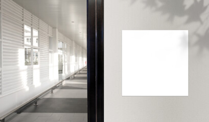 Blank billboard on the wall in an office interior space. Display for mock-up and advertising. Blurred background with nobody.	