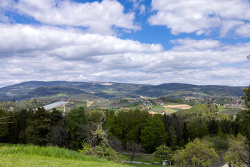 Obraz premium View of the low forested hills and villages in the valley. Austria