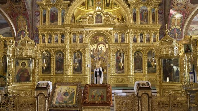 Ornate golden iconostasis with religious paintings in an Eastern Orthodox Church, exuding rich spiritual and cultural heritage.