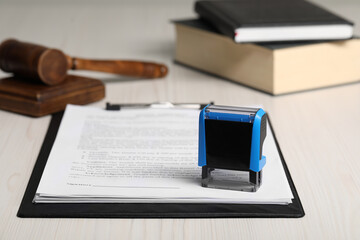 Notary contract. Documents, stamp, gavel and books on white wooden table