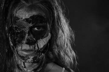 Scary zombie on dark background, black and white effect. Halloween monster