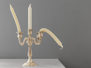 Candlestick with straight and bent candles. Creative concept of male potency problems. Sexual dysfunction in men, problems with health. Metaphor of erectile dysfunction impotence. 